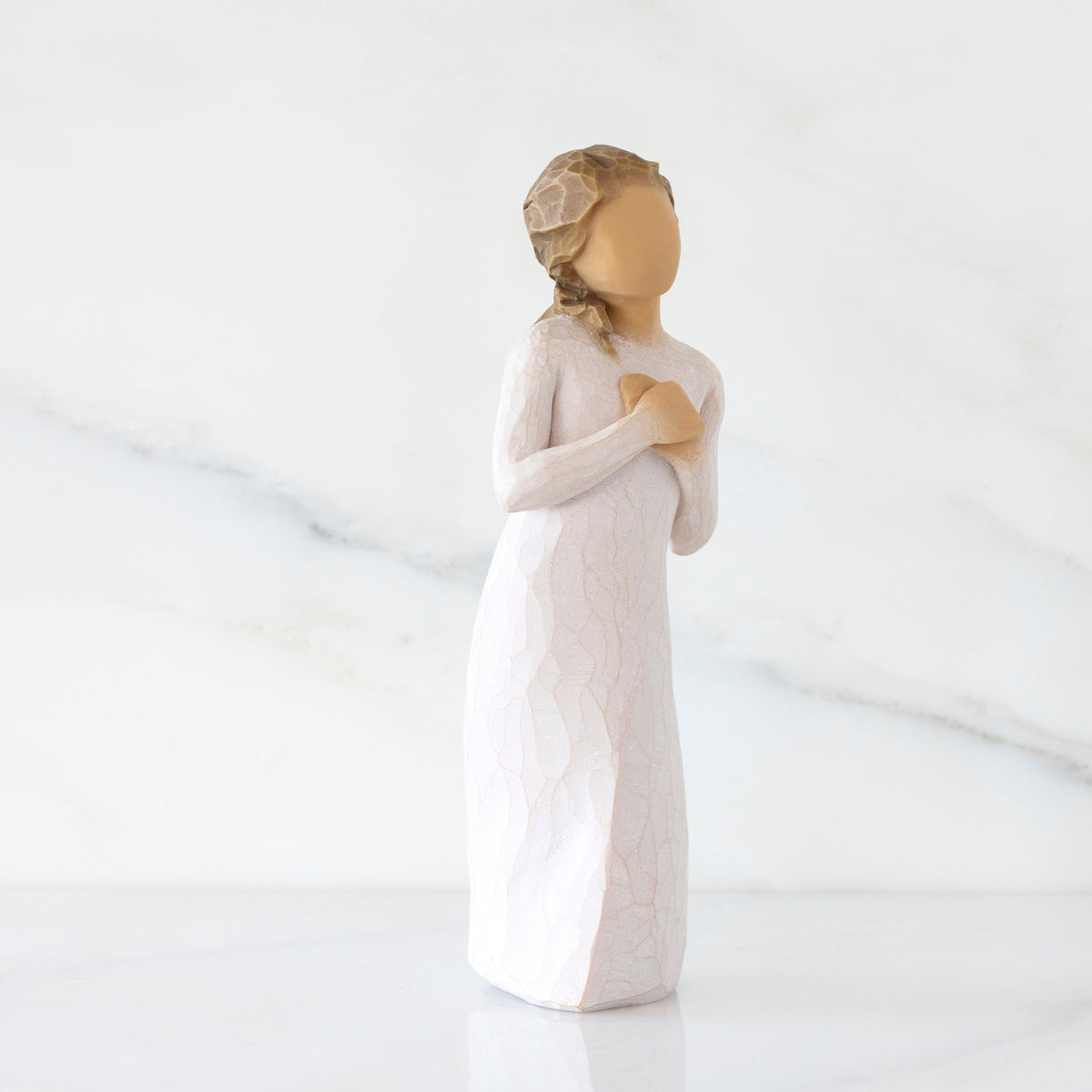 Right-facing view: Standing figure in cream dress with hands to heart in empathetic gesture