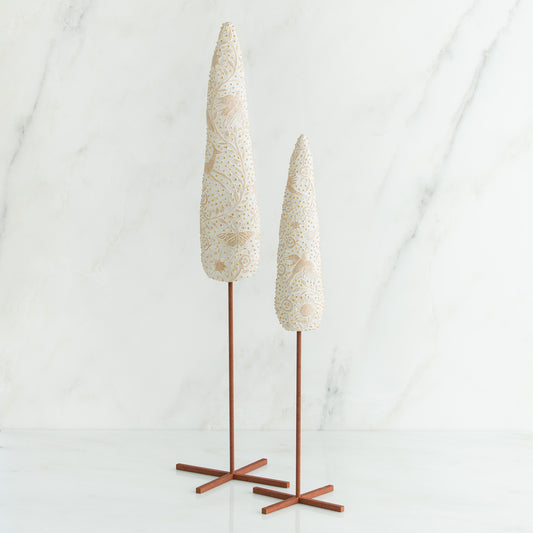 Set of two white tree figurines with wooden stands - all white background