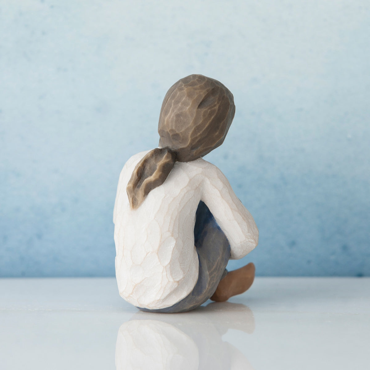 Back view of brunette girl sitting down in white shirt