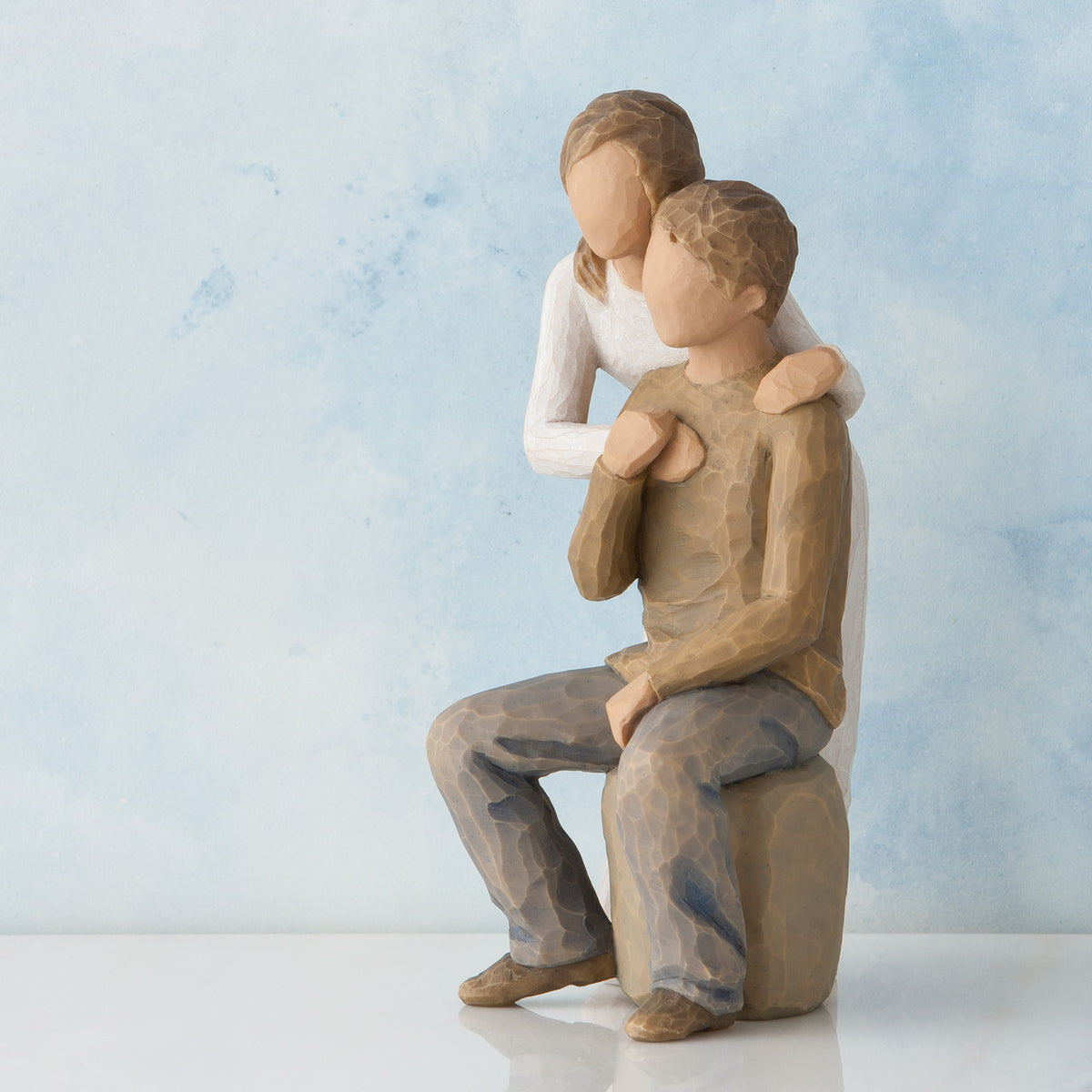 Willow Tree You and Me, 7”h hand-painted resin figure of couple; seated man, woman standing behind with arms around neck, both in neutral clothes, in front of blue painting